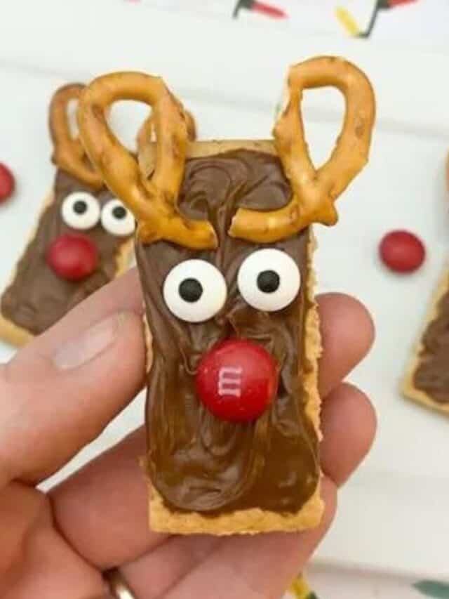 close up view of reindeer themed crackers with chocolate peanut butter with M&M chocolate and pretzels