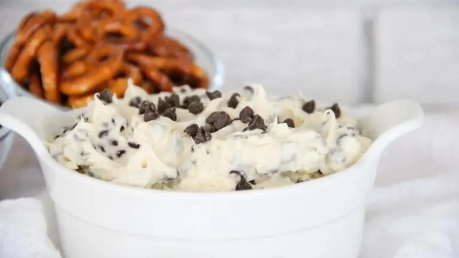 A small bowl filled with chocolate chip cannoli dip.