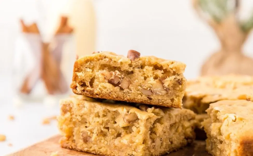 A plate of blondies with nuts and eggnog spices.