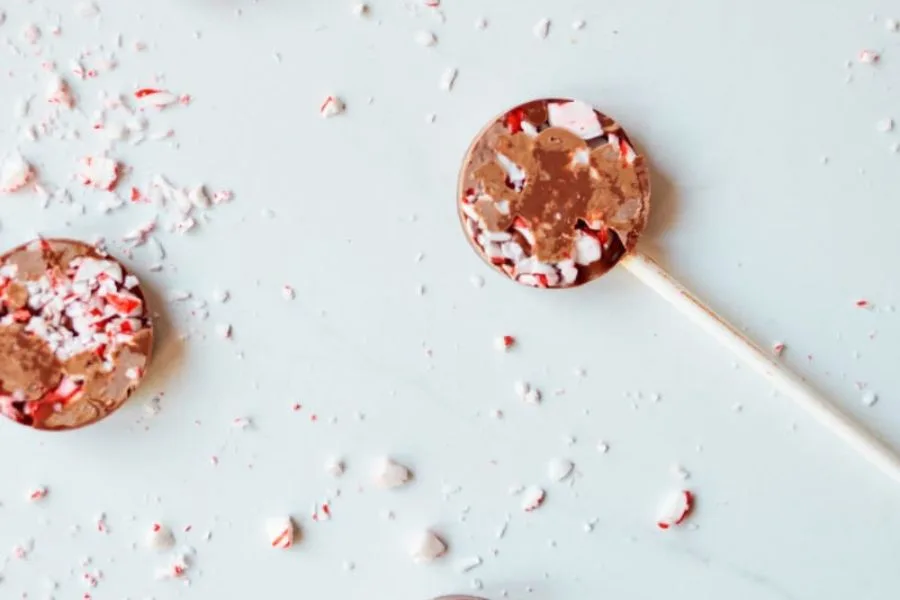 Chocolate and candy cane in lollipop form.