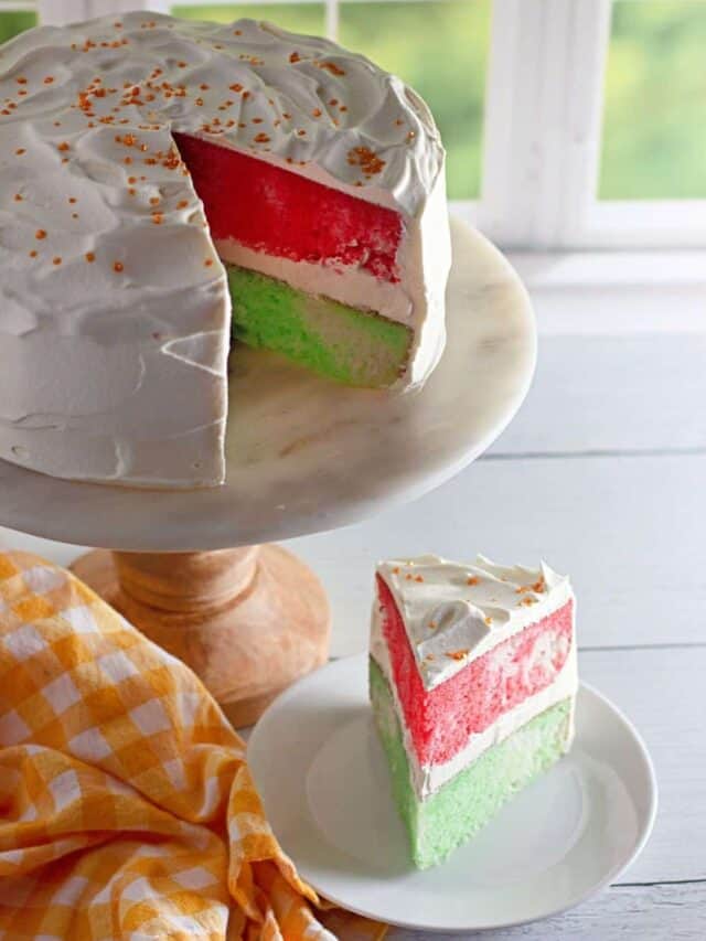 A red and green Jello cake sliced with a view inside