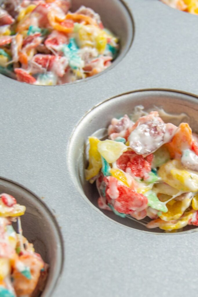 Fruity Pebbles scooped into a cupcake tin