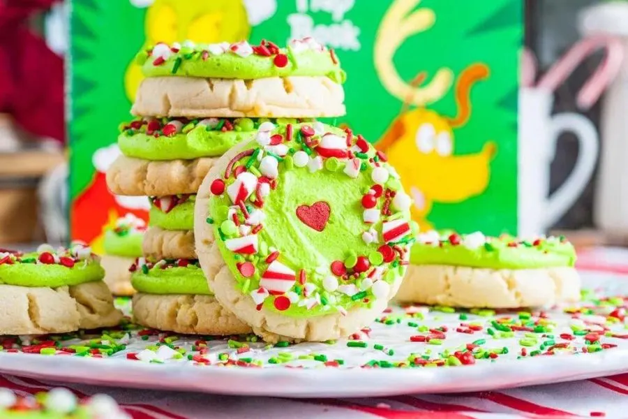 Large sugar cookies with grinch decorations.