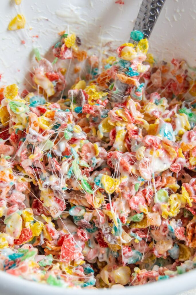 fruity pebble cereal mixed with marshmallow butter mixture