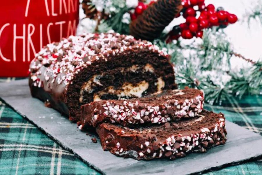 A chocolate cake roll with candy cane crumbles.