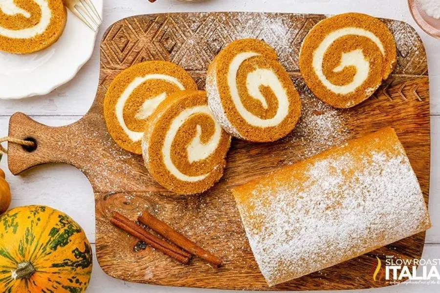 A pumpkin roll cake with cream cheese frosting.