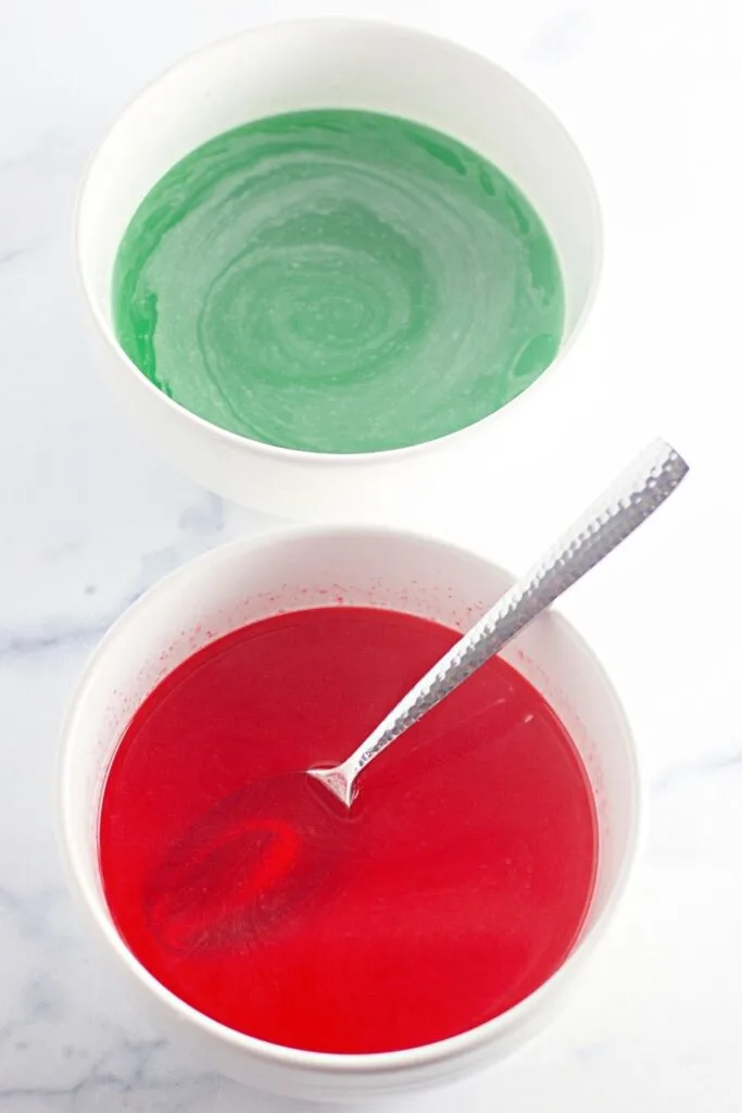 two bowls of jello, one red and one green
