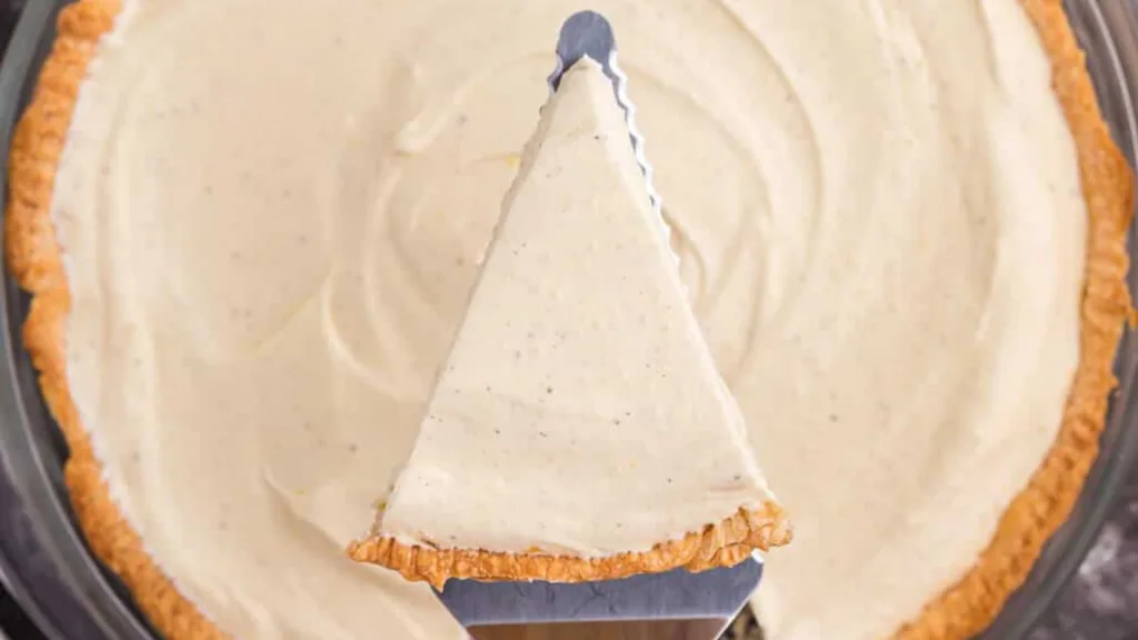 close up view of eggnog pie with one slice on a pie spoon