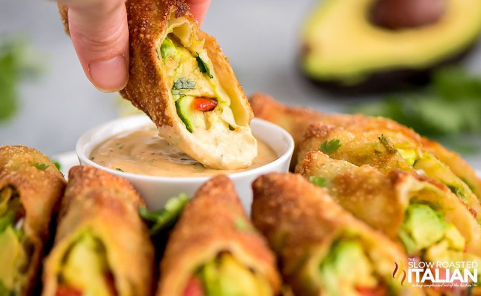  A plate of egg rolls filled with avocado chunks.