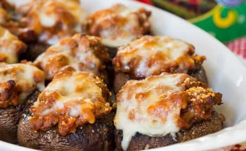  Beef and sauce stuffed mushrooms with melty cheese over top.