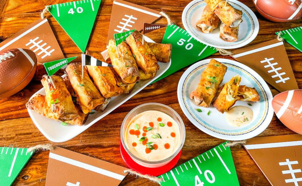Egg rolls filled with buffalo chicken and set up for a football party.