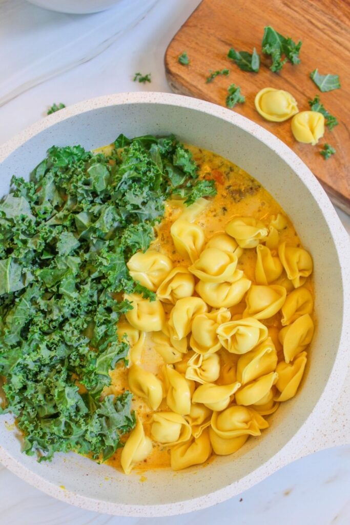 kale and tortellini in a pot