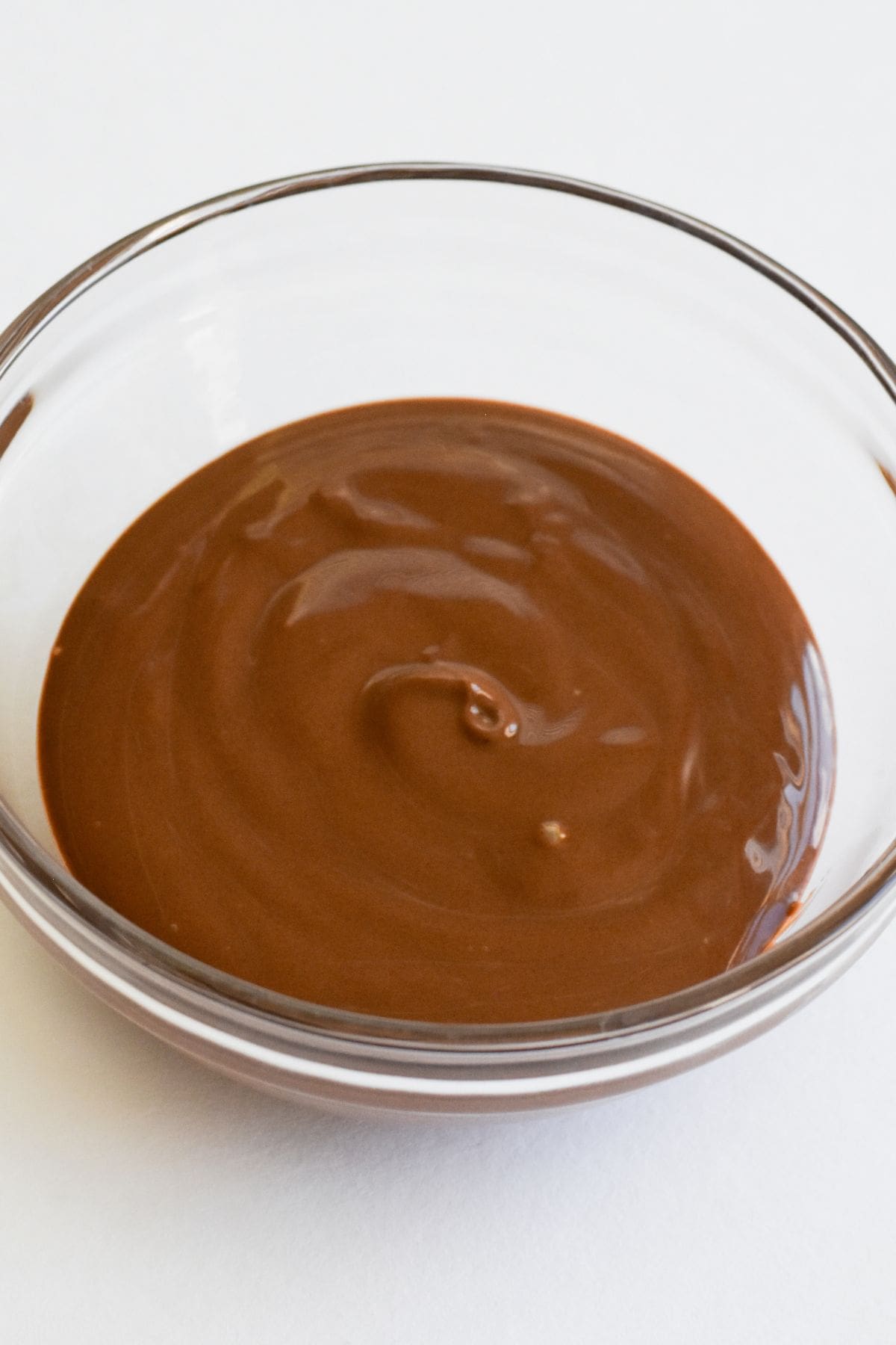 Melted chocolate in a glass bowl.