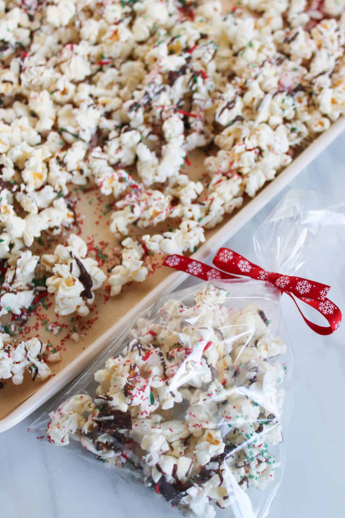 Adding prepared popcorn to treat bags.